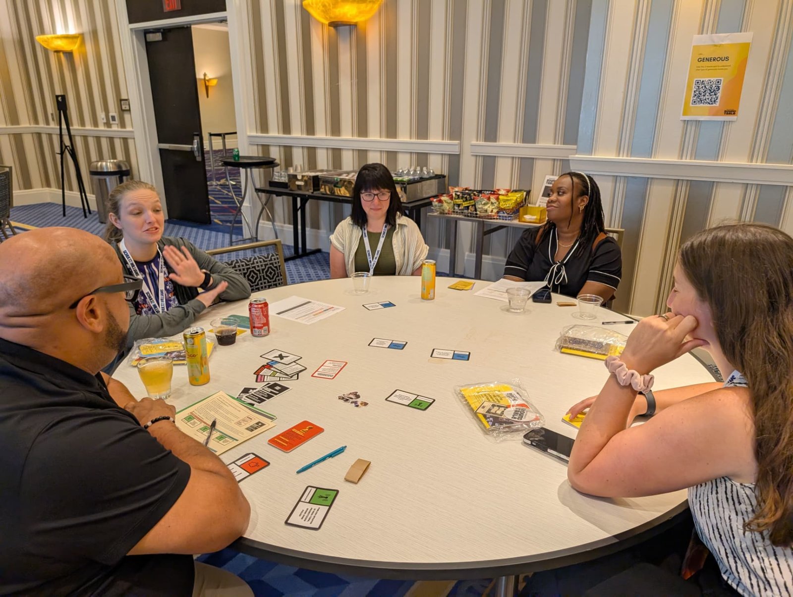 Ben Williams and nonprofit leaders playing the Generosity Roundtable card game around a table at National Harbor